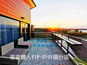 a balcony of a house with a view of the ocean at Kenting Gala Vineyard in Nanwan