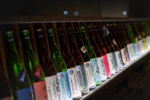a row of wine bottles lined up on a shelf at Iizaka Onsen Surikamitei Ohtori in Fukushima