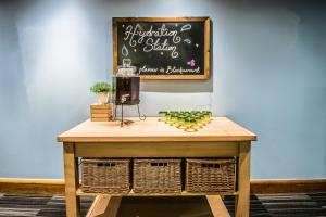 a table with baskets and a sign on a wall at Holiday Inn Cambridge by IHG in Cambridge +108 photos