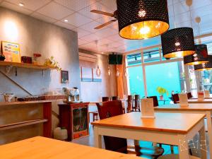 a restaurant with tables and chairs in a room at Sun Moon Heart Hostel in Puli