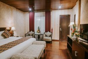Postel nebo postele na pokoji v ubytování Arthur Suites by Mahavilas