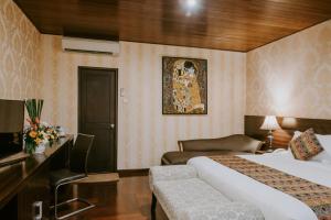 Postel nebo postele na pokoji v ubytování Arthur Suites by Mahavilas