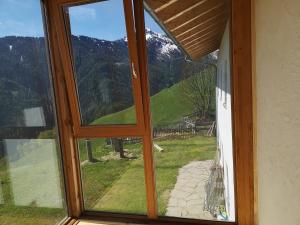 a window with a view of a snow covered mountain at Knappnhof in Campo di Trens +5 photos