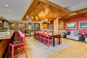 a restaurant with red chairs and a long table at Holiday Inn - Nampa, an IHG Hotel in Nampa