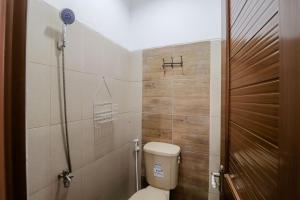 a bathroom with a toilet and a shower at Java Homestay in Yogyakarta