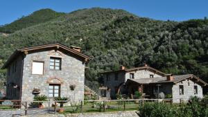 dos casas de piedra frente a una montaña en Le Macine Del Confluente, en Badalucco