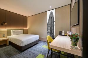 a hotel room with a bed and a table at Aerotel Kuala Lumpur (Airport Hotel) - Gateway@klia2 in Sepang