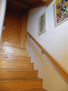 a stairway with wooden steps and paintings on the wall at Apartment Mamut in Premantura