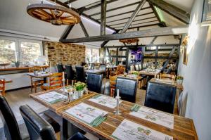 a dining room with a long table and chairs at Venngasthof Zur Buche in Monschau