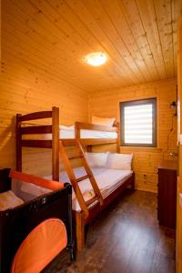 a bedroom with two bunk beds in a cabin at WICIE Domki na Polanie in Wicie
