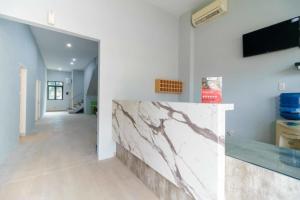 a hallway with a marble counter in a house at RedDoorz @ Helvetia Medan 2 in Pulauberayan