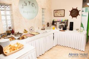 a kitchen with white counters with food on them at Hotel Almira in Agia Triada