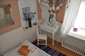 a bedroom with a vanity and a mirror and a chair at Das Pernerhaus in Pöllau