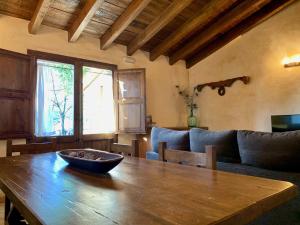 a wooden table with a bowl on it in a living room at Can Vila in Tavertet