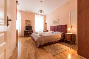 a bedroom with a bed and a television in it at Apartments Villa Devana in Opatija