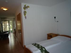a bedroom with a white bed with a plant on it at biozertifiziertes Hotel Höpfigheimer Hof mit Wein-Shop in Steinheim an der Murr