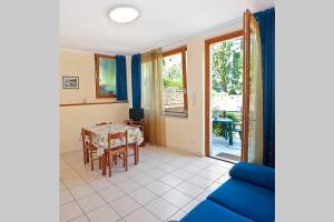 a living room with a table and a blue couch at Casa Facchinetti Blue apartment in Malcesine