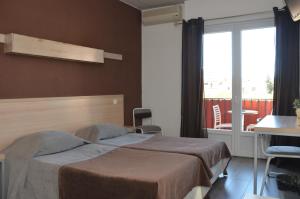 Postel nebo postele na pokoji v ubytování Hotel Le Terminus