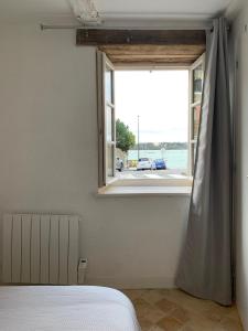 a bedroom with a window with a view of a street at Le Cap Solidor in Saint Malo