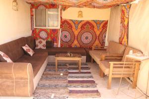 a living room with a couch and a table at Pyramids Overlook Inn in Cairo