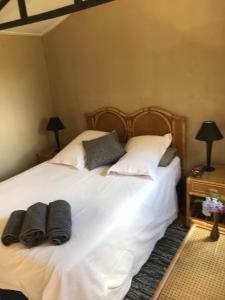 a bedroom with a bed with white sheets and pillows at BARE NECESSITIES, NUDIST ONLY VENUE Naturist, clothes free in Swellendam