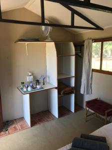 a room with a bed and a table in a room at BARE NECESSITIES, NUDIST ONLY VENUE Naturist, clothes free in Swellendam