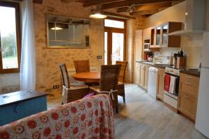 a kitchen and dining room with a table and chairs at La maison triangulaire in Roussines +16 photos