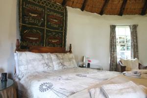 a bedroom with a bed with a poster on the wall at Baldinnie Cottages in Nottingham Road