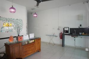 a room with a kitchen with a counter and a table at S & S Guest House Kuantan in Kuantan