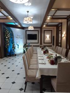 a large dining room with a long table and chairs at Hotel Complex Druzhba in Buzuluk