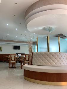 a restaurant with a couch in the middle of a room at Hotel - Motel Flower in Gropello Cairoli