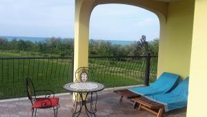 a patio with a table and chairs and a balcony at Villa Marianna in Vasto