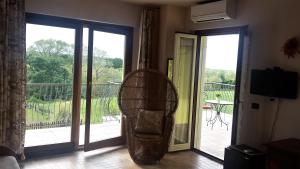 a living room with a door open to a balcony at Villa Marianna in Vasto