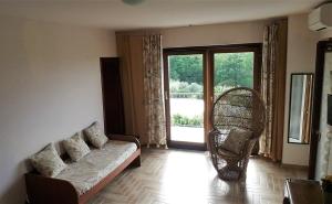 a living room with a couch and a large window at Villa Marianna in Vasto