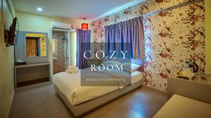a room with a bed with a sign that says room at Sweetloft Hotel Don Muang in Bangkok