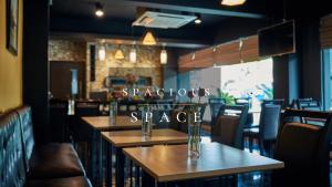 a restaurant with tables and chairs and a sign that readspostsspace at Sweetloft Hotel Don Muang in Bangkok