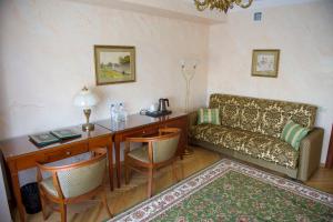 a living room with a desk and a couch at Danilovskaya Hotel in Moscow