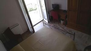 a bedroom with a bed and a large window at Villa Marianna in Vasto