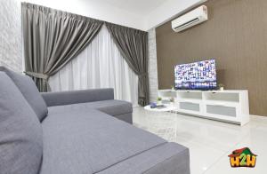 a living room with a couch and a tv at H2H - Neo Casual - Majestic Ipoh Town Center - 8pax in Ipoh