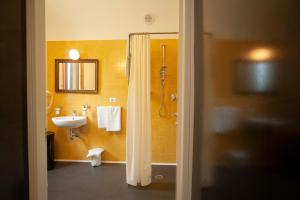 a bathroom with a sink and a shower with yellow tiles at Sopra il Limoneto in Cetara