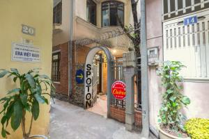 an entrance to a building with a sign on the door at OYO 619 Chikoo Homestay spot-on in Hanoi