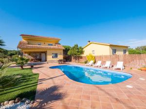 a villa with a swimming pool in front of a house at Club Villamar - Admirada in San Poncio