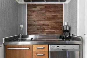 una cocina con fregadero y encimera en Divine Living - Apartments, en Estocolmo