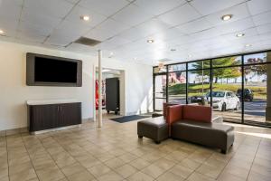 a waiting room with a chair and a television in a building at Rodeway Inn Baltimore - Inner Harbor South in Baltimore