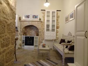 a living room with a couch and a stone fireplace at Muse Mese in Halki