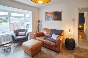 ein Wohnzimmer mit einem Sofa und einem Stuhl in der Unterkunft Host & Stay - Willow View in Saltburn-by-the-Sea