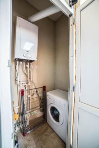 a laundry room with a washer and dryer at Comfy Apartment in Tbilisi City