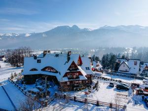 an aerial view of a house in the snow at Aparthotel Delta Boutique in Kościelisko