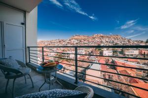 a balcony with a view of a city at Comfy Apartment in Tbilisi City