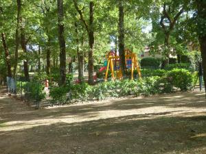 a playground in a park with a slide at La Résidence Vacances Mondésir appartement 3 étoiles in Monflanquin